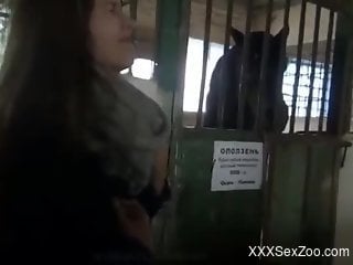 Blonde bends over to happily take a horse's hard cock